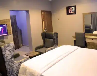 Super Deluxe Room at Fountain Blu Hotel and Apartment, Abeokuta with top-tier luxury amenities including air conditioning, high-speed Wi-Fi, a flat-screen TV, and a well-arranged workspace
